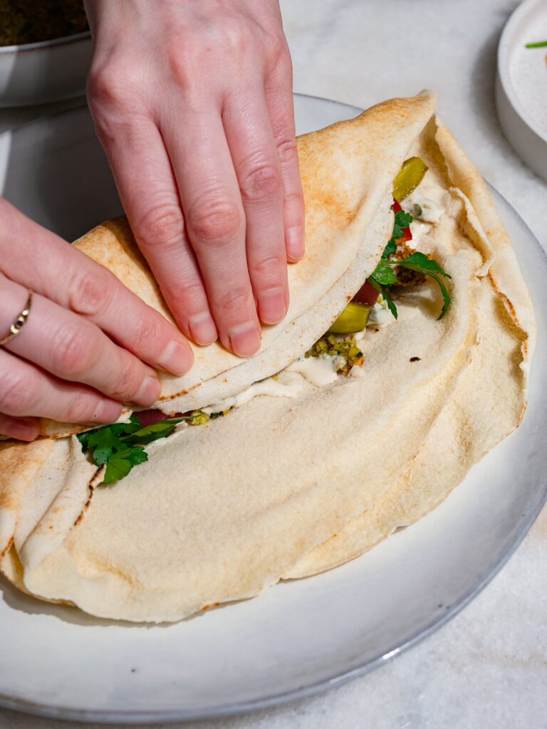 Falafel Wrap wird eingerollt.