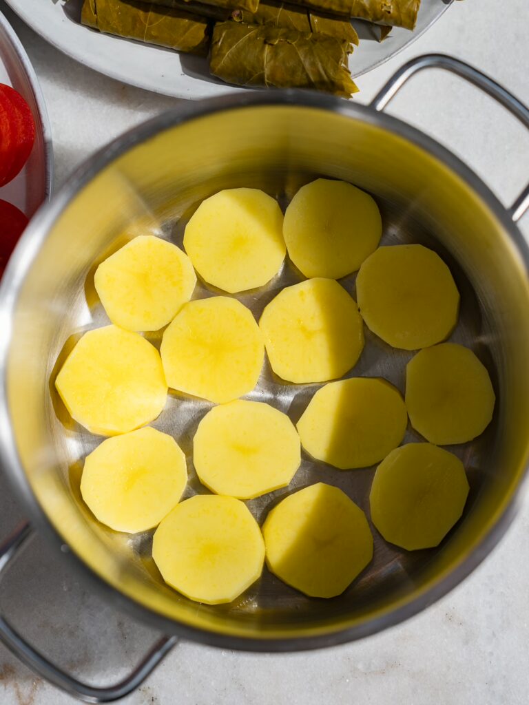 A pot was lined with potato slices.