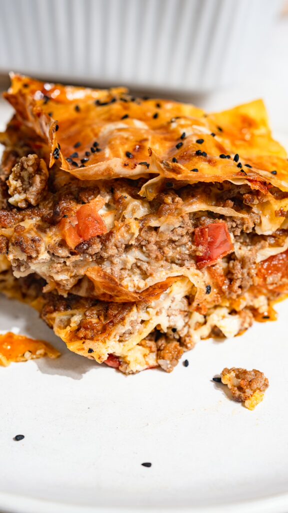 A piece of börek with minced meat served on a plate.
