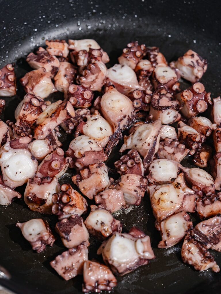 The octopus is seared in a pan.