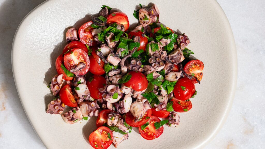 Cooked pulpo salad served in a bowl.
